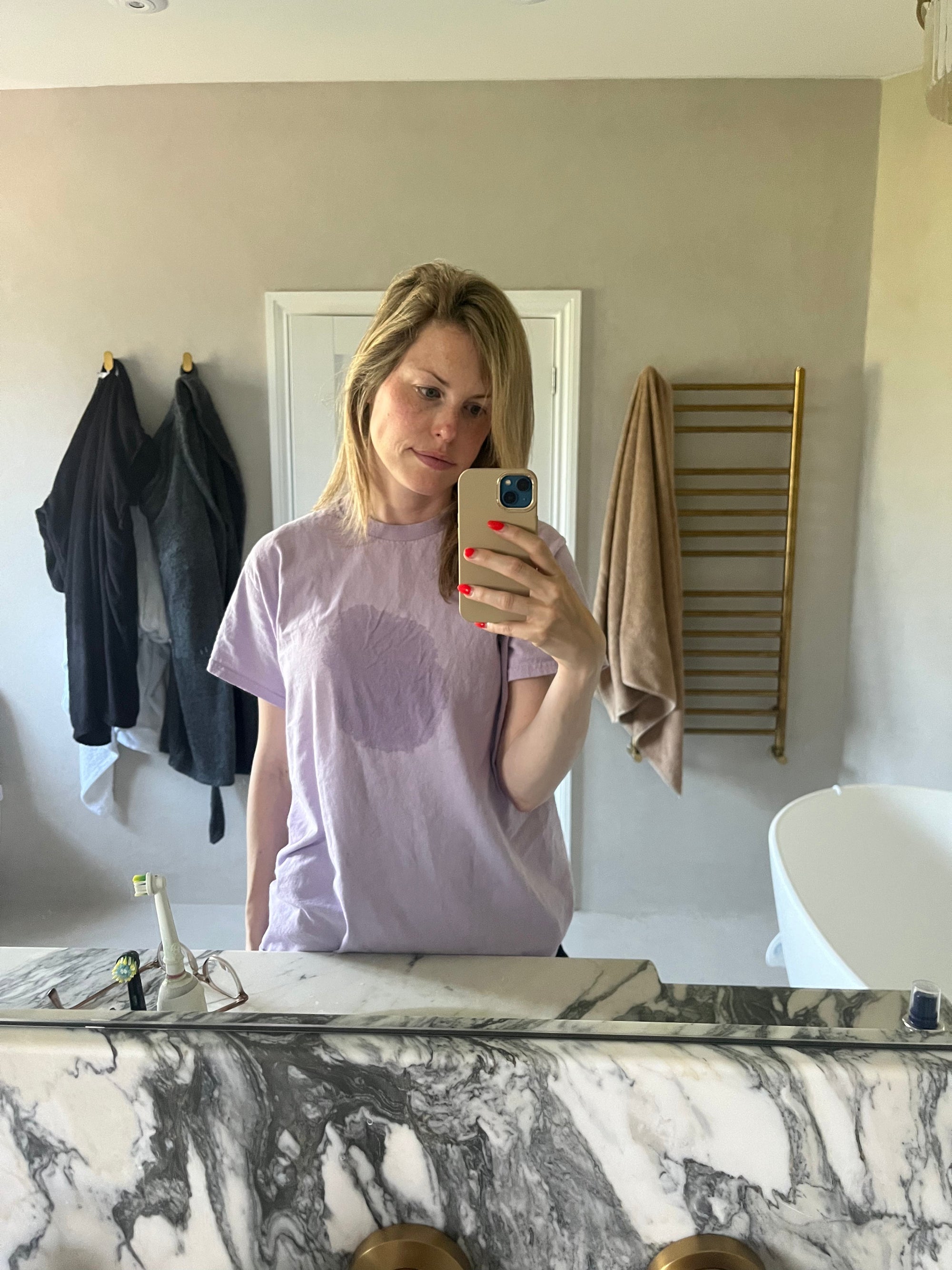 Breastfeeding mum with wet patches from breast milk leaks